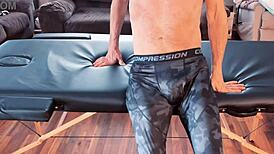 Stretching in compression pants on massage table