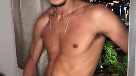 Safado teen jerks huge load while peeking out building window.