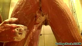 Teen dorm girl soaps shaved pussy in steamy shower rub