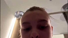 A horny teen fingers her tight pussy in public changing room