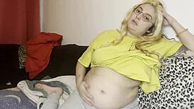 He massages her swollen hairy belly on the couch before rough play